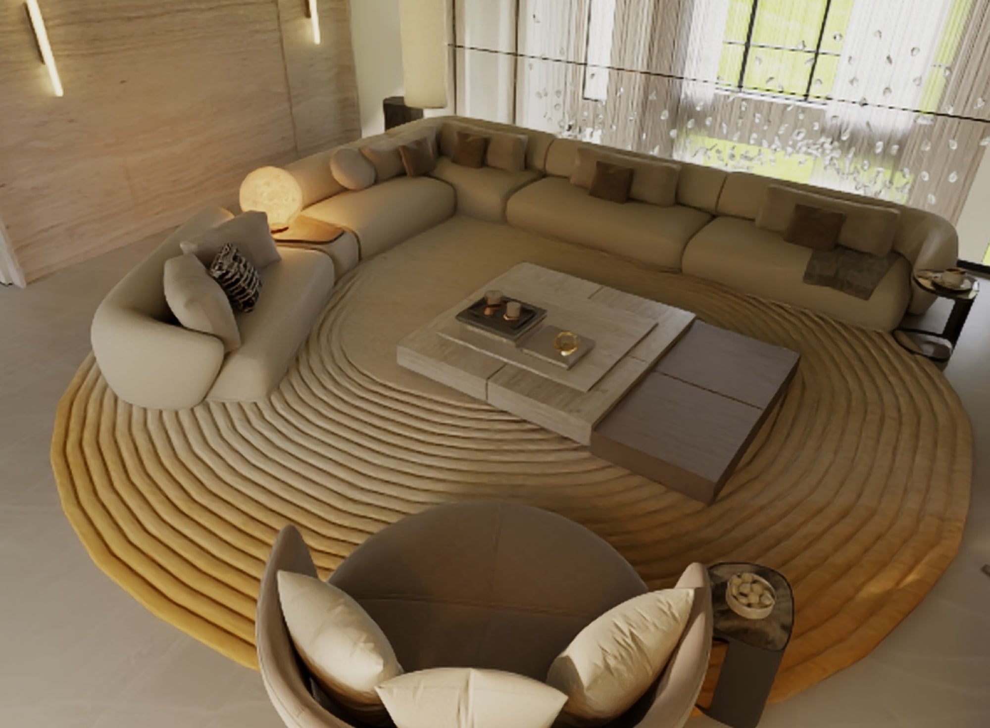 An overhead view of a deep curved sectional and a swivel chair on a raked circular rug, beside a travertine wall, designed by Radwa Interiors.