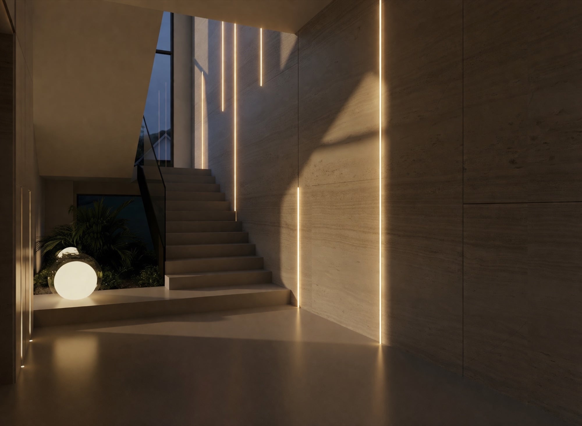 A stone staircase lit by recessed vertical strips in a travertine wall, with a glowing globe on the lower landing, designed by Radwa Interiors.