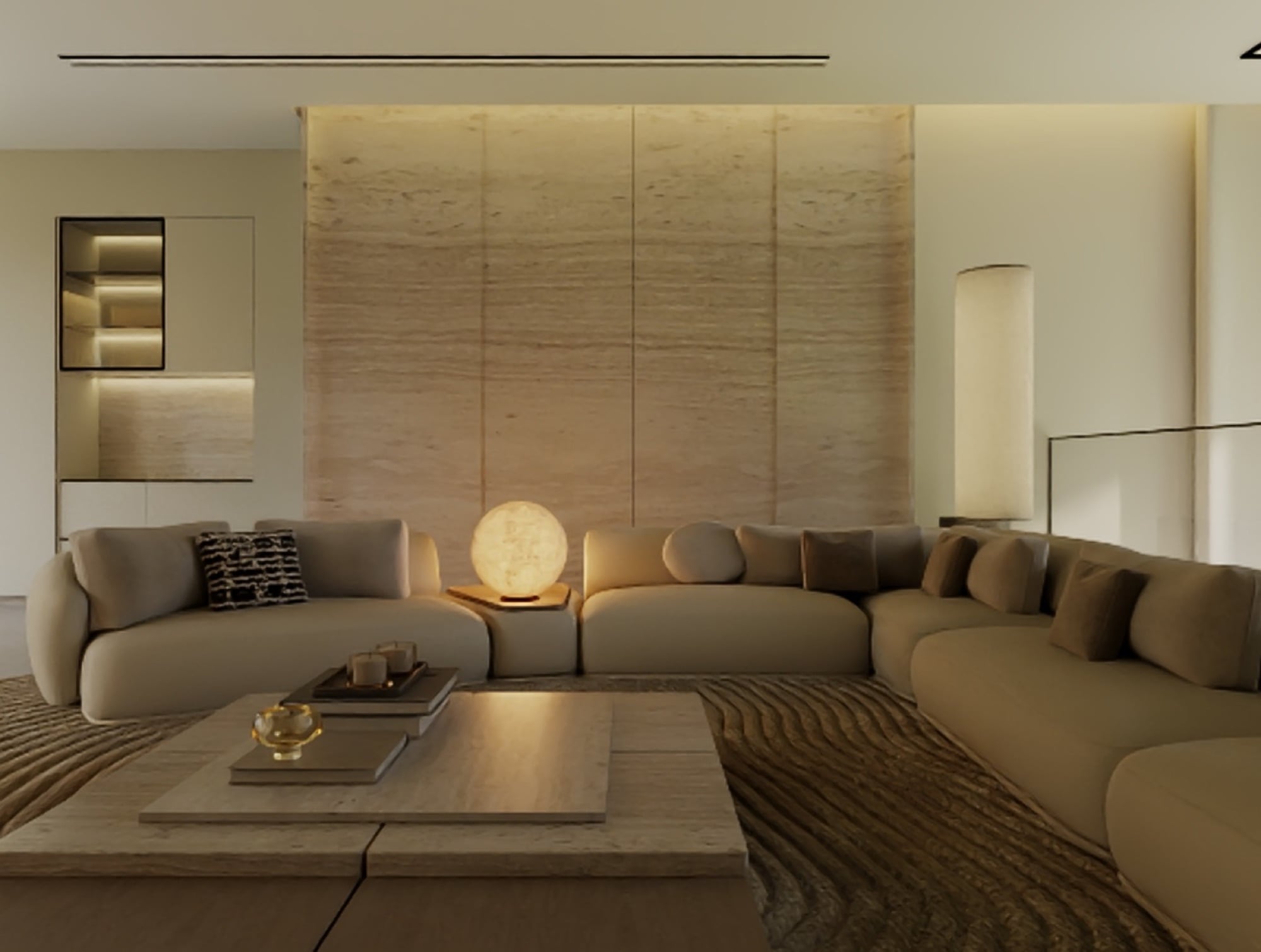 A living room with a book-matched travertine wall and a glowing alabaster globe lamp beside deep sectional seating, designed by Radwa Interiors.