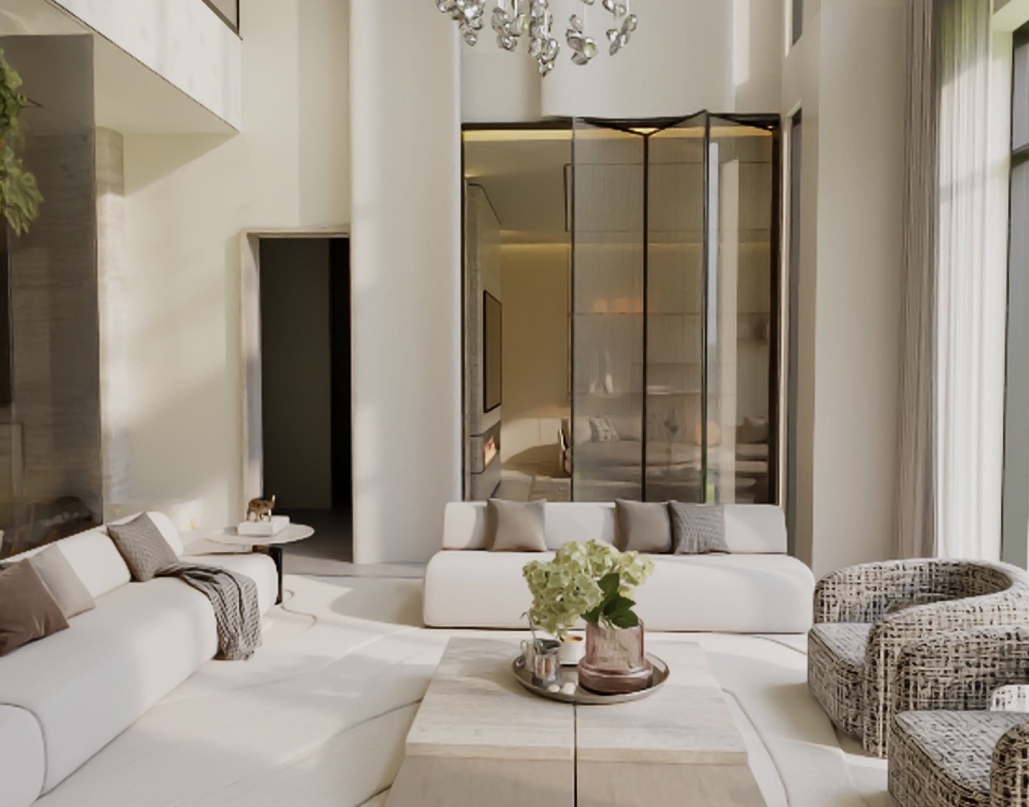 A double-height living room with white sofas, woven armchairs and a glass-drop chandelier beside a mirrored partition, designed by Radwa Interiors.