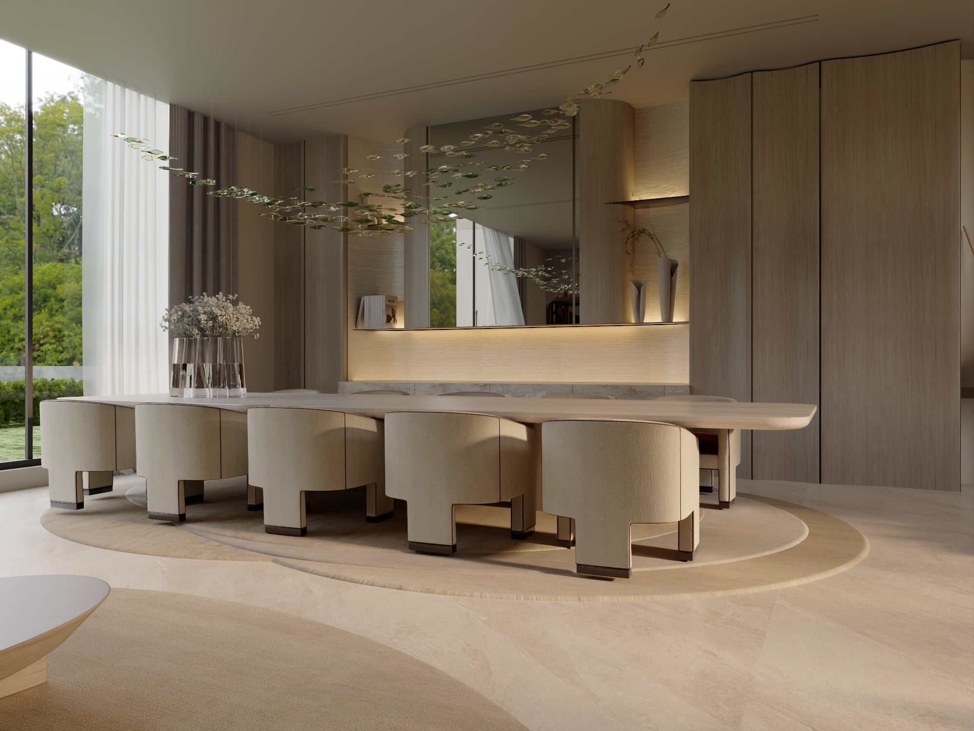 A dining table with cream sculpted chairs on a round rug, below a delicate leaf mobile and a backlit timber sideboard, designed by Radwa Interiors.