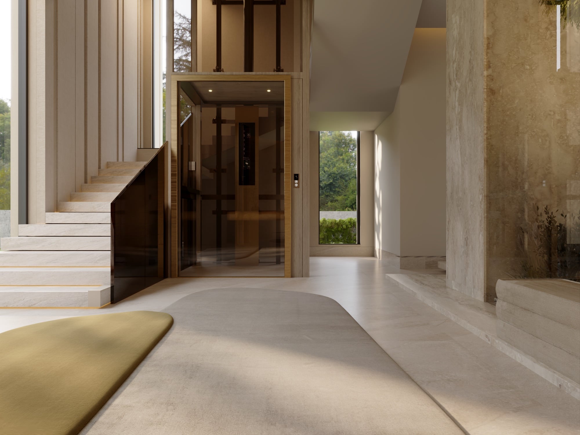 A bronze-glass lift beside a stone staircase, with a mustard rug and a travertine wall in a double-height hall, designed by Radwa Interiors.