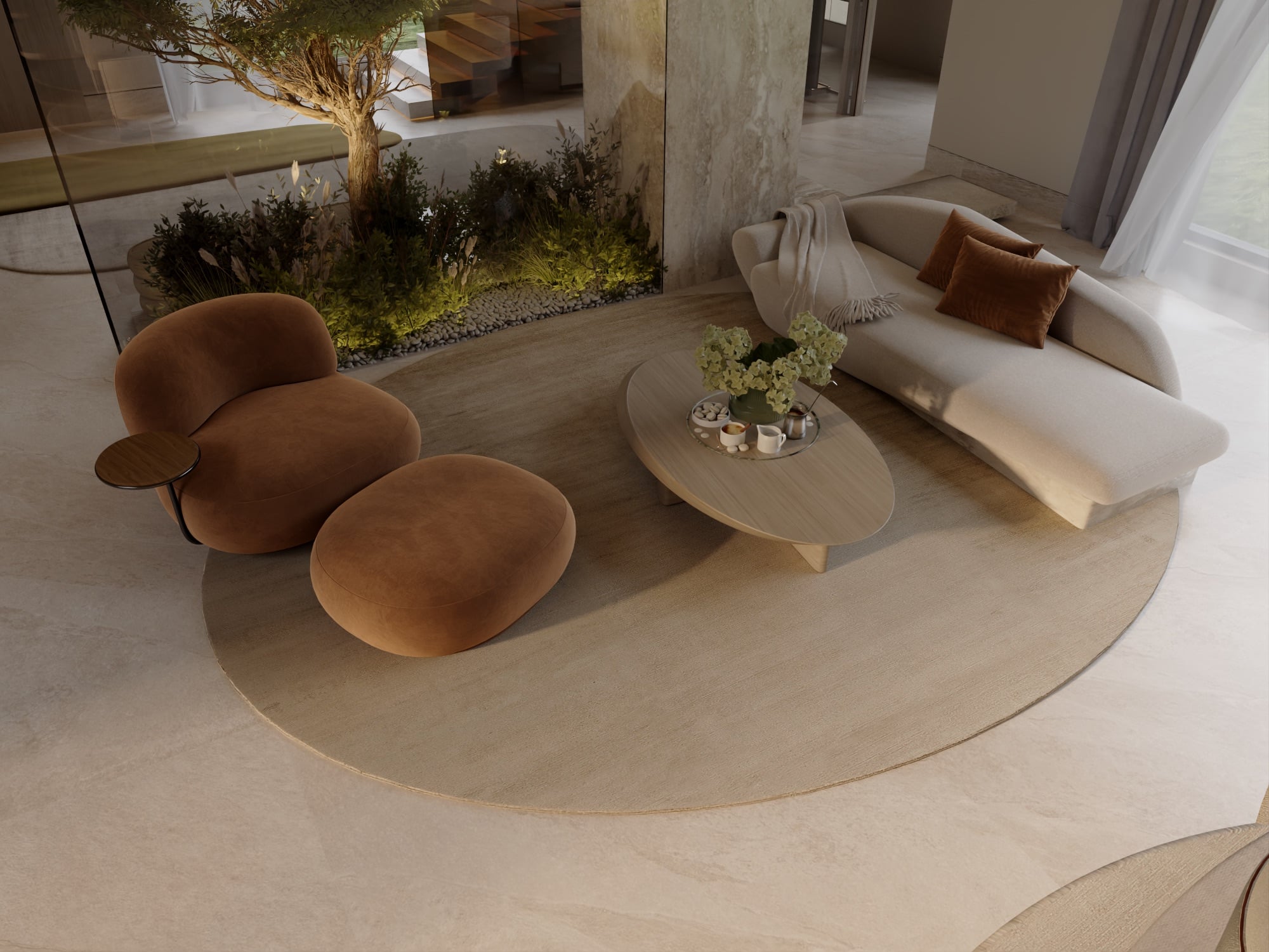 An overhead view of a cream sofa and tan armchair with a round ottoman, beside a planted courtyard behind glass, designed by Radwa Interiors.