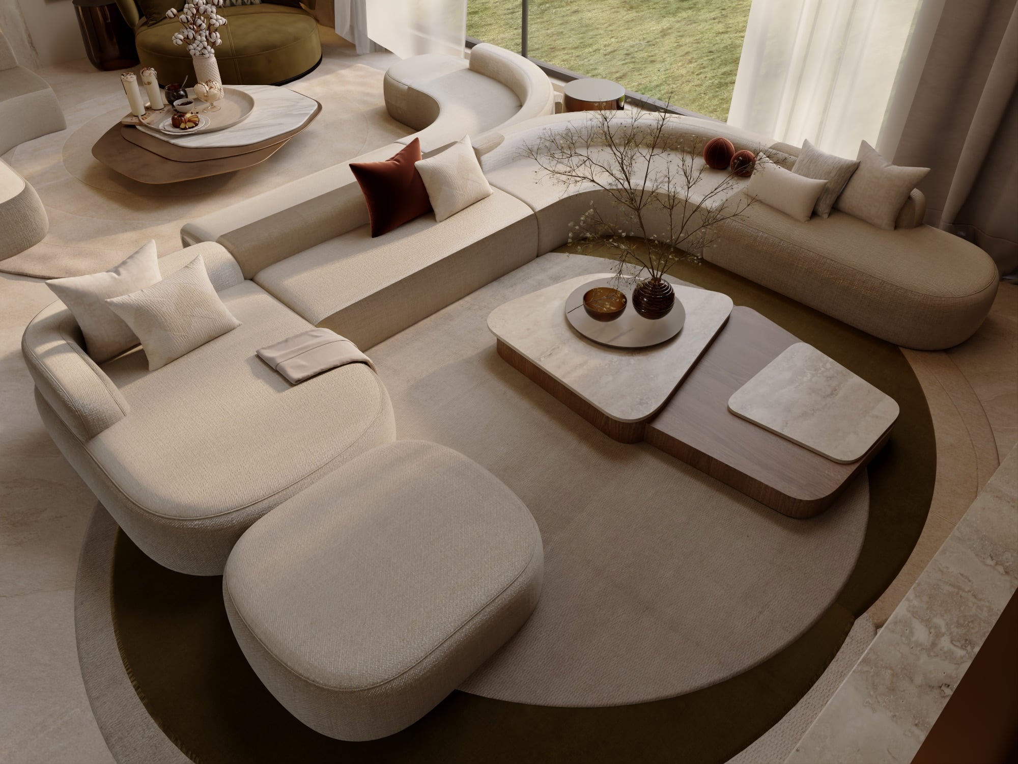 An overhead view of a curved cream sectional with rust cushions around low stone and timber tables on an olive rug, designed by Radwa Interiors.
