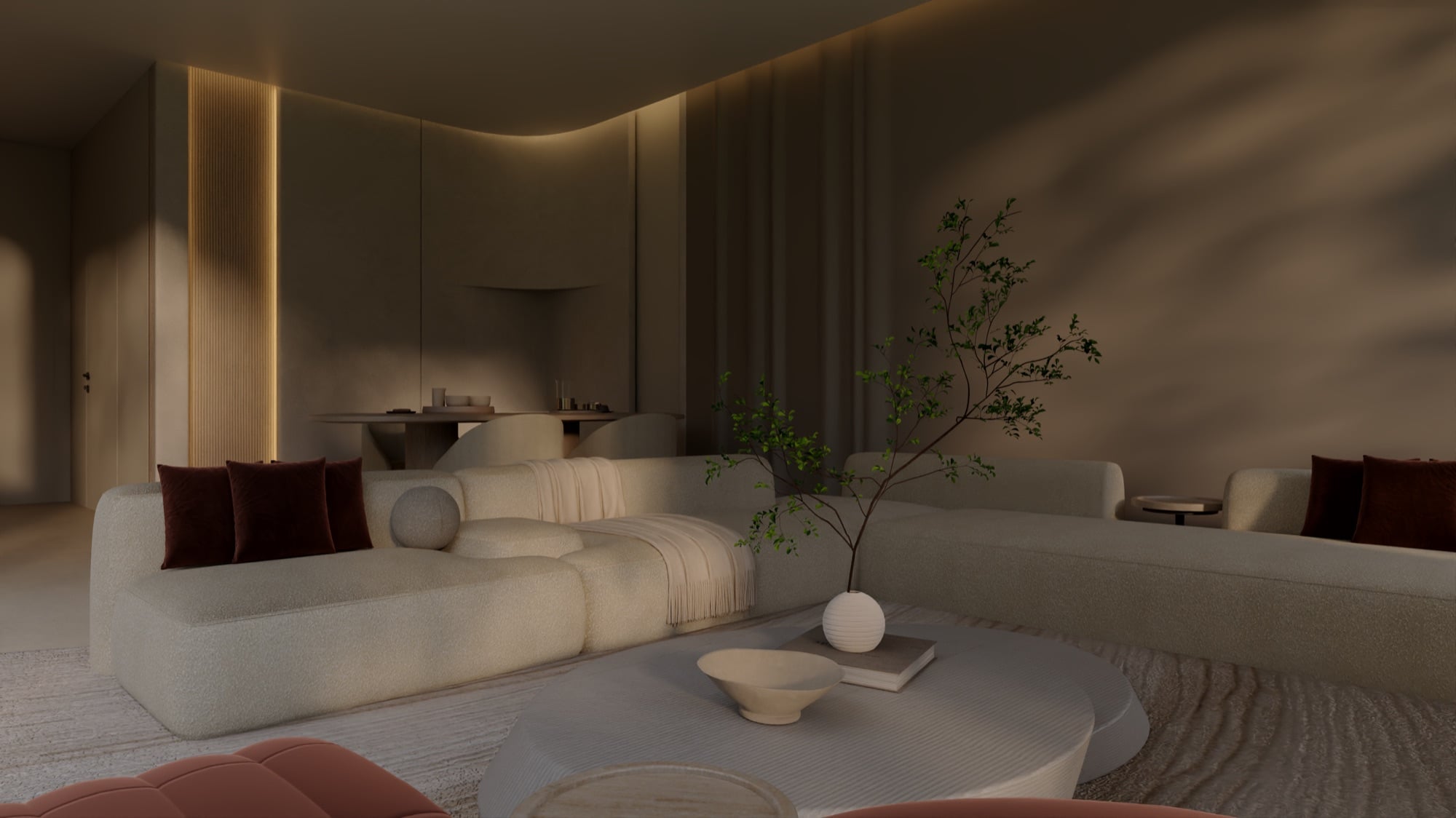 A softly lit living room with cream seating, burgundy cushions and a slender indoor tree beside a low table, designed by Radwa Interiors.