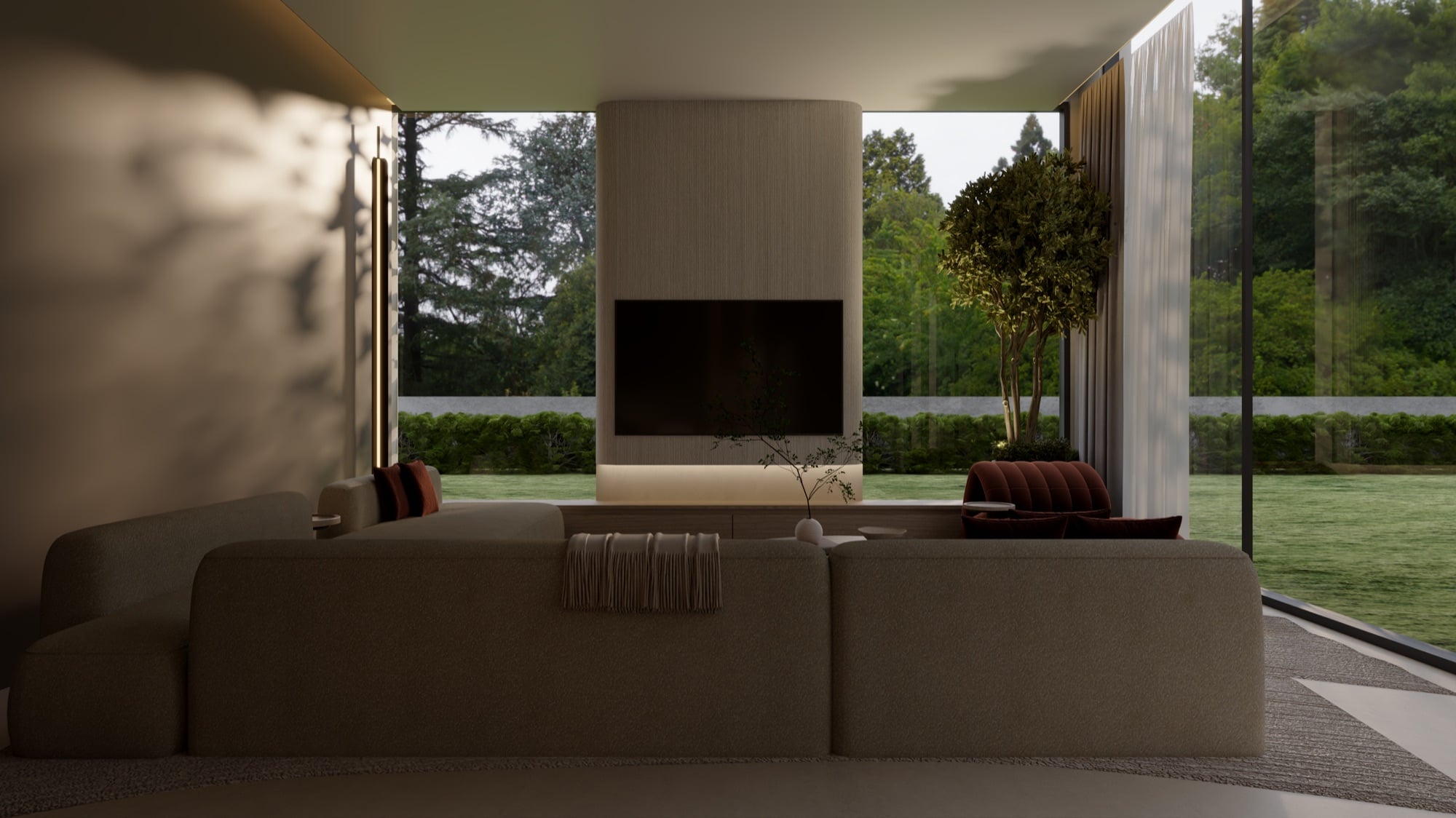 A cream sectional facing a screen set into a timber panel, framed by full-height glazing onto the garden, designed by Radwa Interiors.
