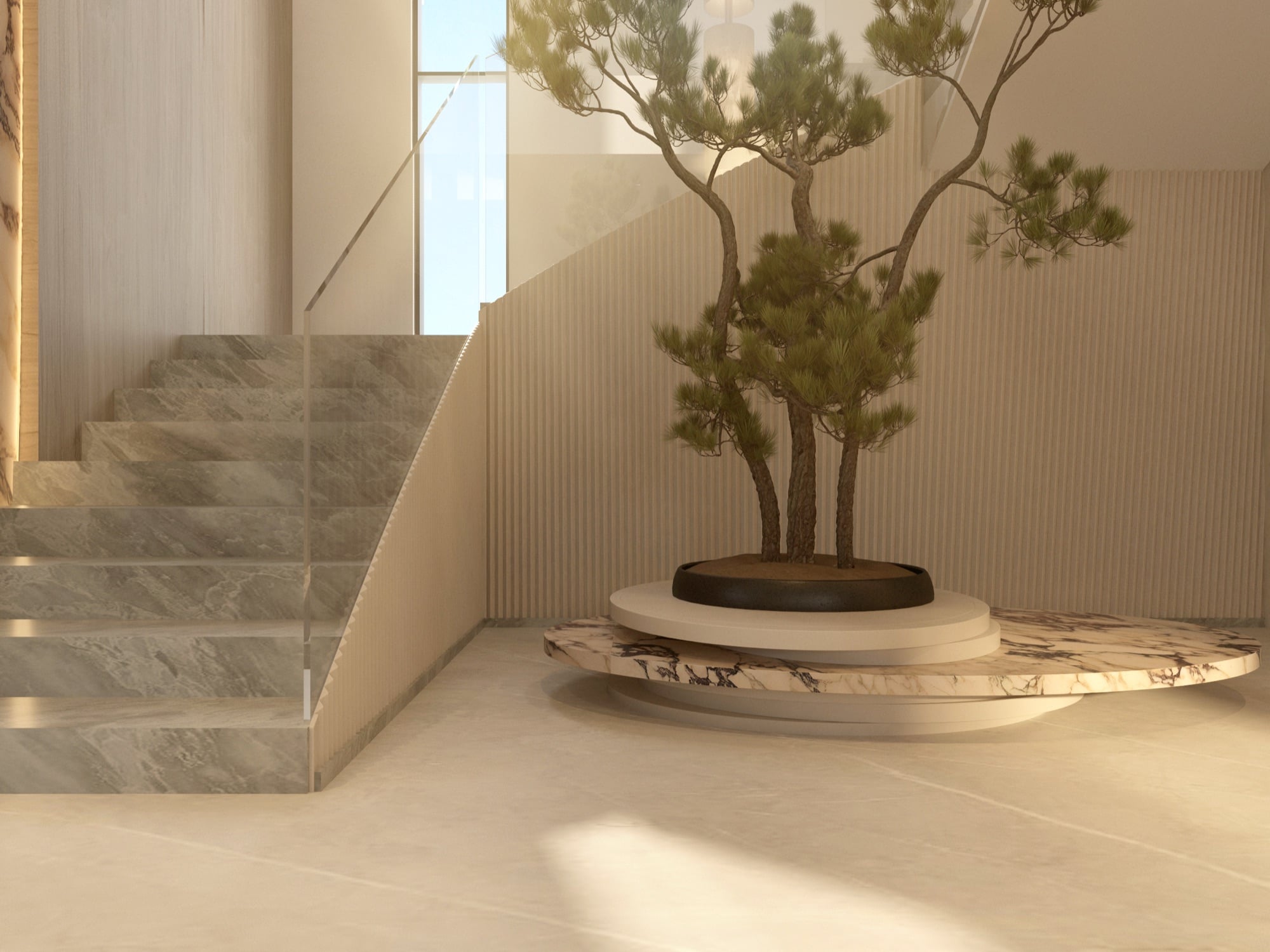 A multi-stemmed pine set in a dark bowl on a stepped marble plinth, beside a glass-balustraded staircase, designed by Radwa Interiors.