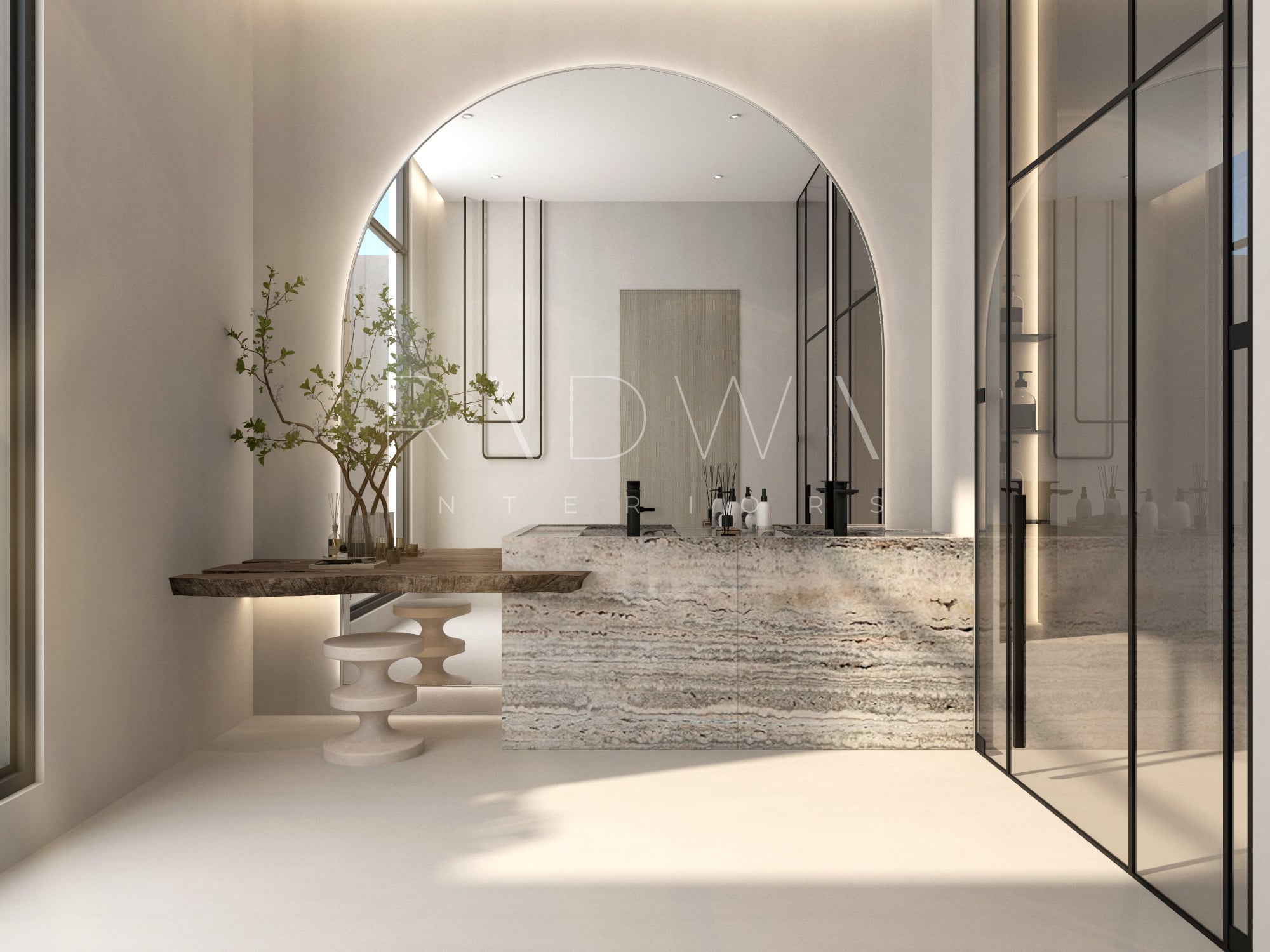 A bathroom with a heavily veined stone vanity under an arched backlit mirror, beside a timber shelf and fluted stools, designed by Radwa Interiors.