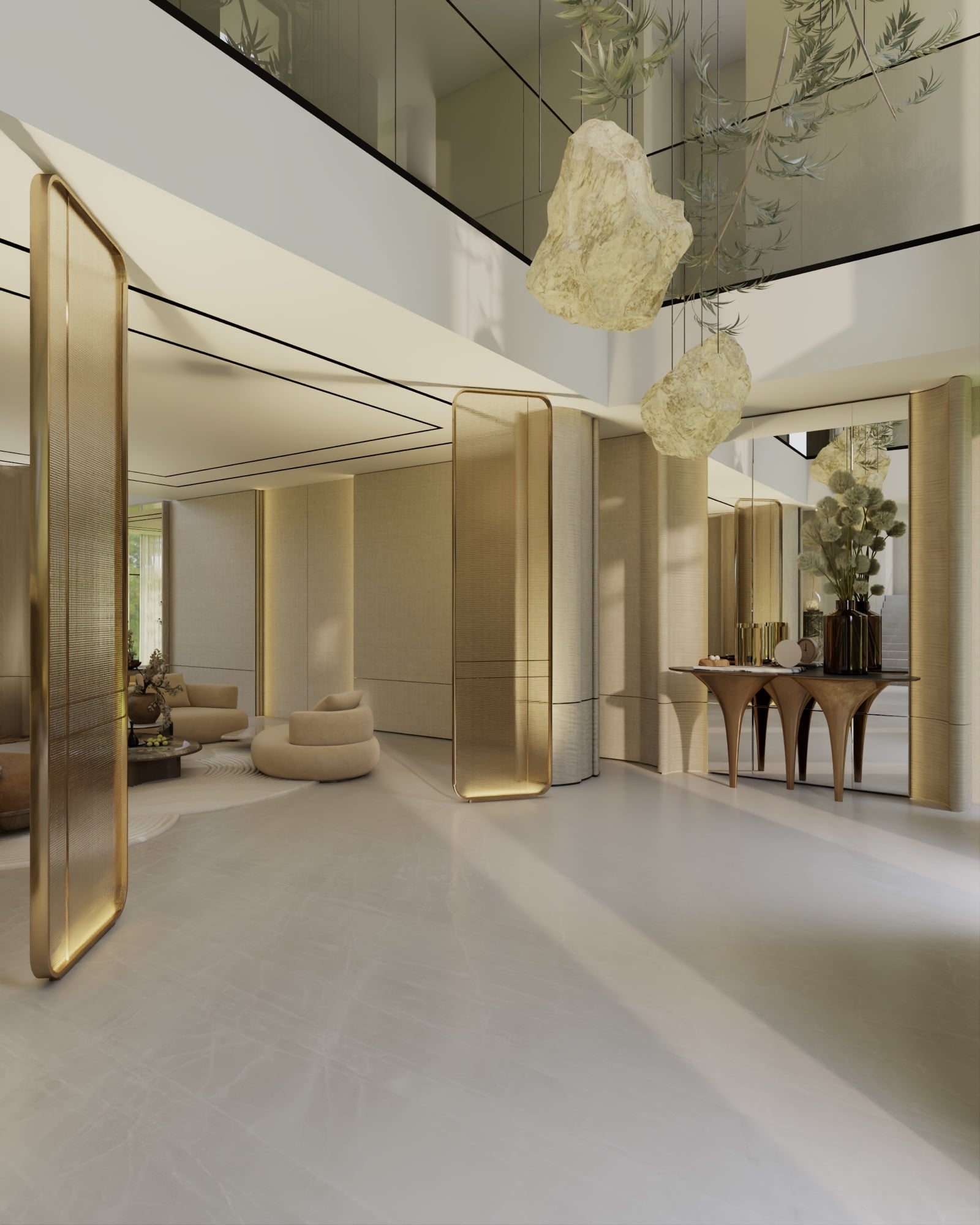 A double-height entrance with tall brass pivot doors, alabaster pendants and a sculptural console below a mezzanine, designed by Radwa Interiors.